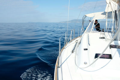 Sailboat sailing in sea against sky