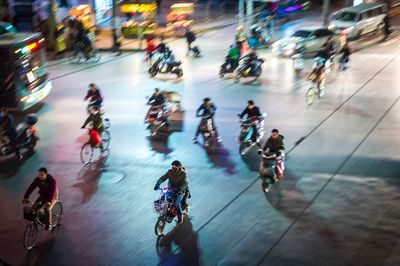 High angle view of people walking on road in city