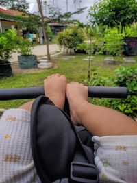 Low section of man sitting in yard