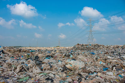 Stack of garbage against blue sky