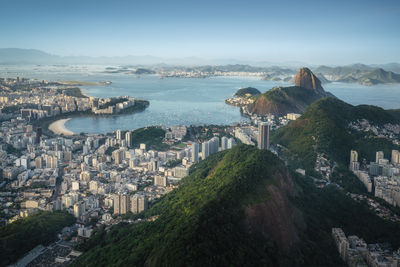 High angle view of townscape by sea against sky