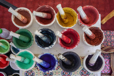 High angle view of dried watercolors in small porcelain mortars