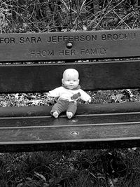 Full length of boy sitting on bench