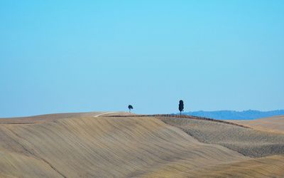 Scenic view of desert against clear blue sky