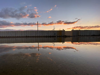 Scenic view of lake against sky at sunset