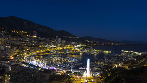 High angle view of city lit up at night