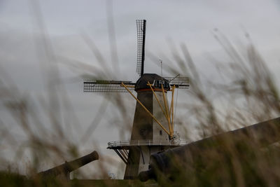 Traditional windmill against sky