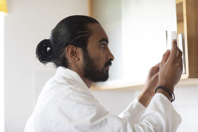 Young man pharmacist checking a tablets pack