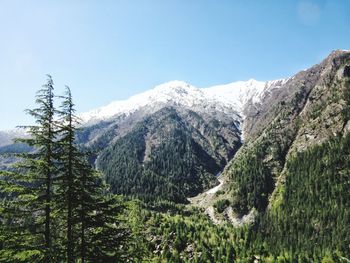 Scenic view of snowcapped mountains against clear sky