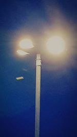 Low angle view of illuminated street light against sky at night