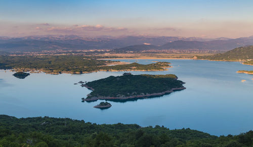 High angle view of sea and mountains against sky