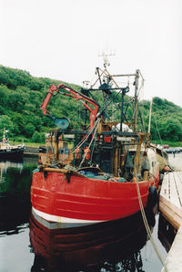 Boats moored on sea against sky