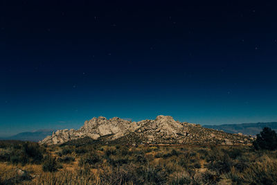 Scenic view of mountains against blue sky