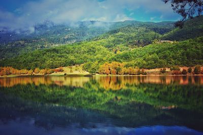 Scenic view of mountain reflecting on lake