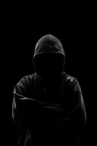 Hacker standing over black background