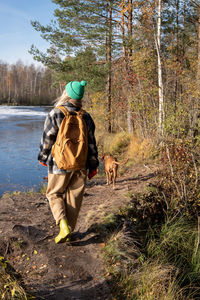 Rear view of man standing in forest