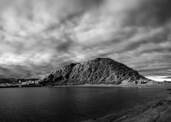 Scenic view of sea and mountains against sky