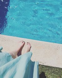 Low section of woman standing on poolside