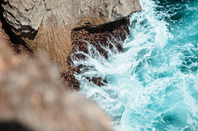 View of water flowing through rocks