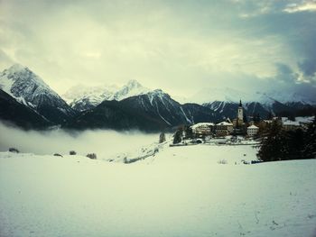 Scenic view of snow covered mountains against sky