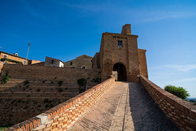 Low angle view of historical building against blue sky