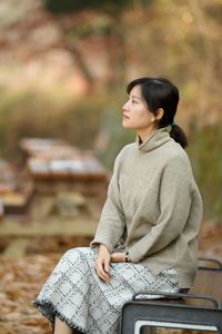 Side view of a young woman sitting on seat