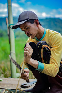 Midsection of man holding umbrella