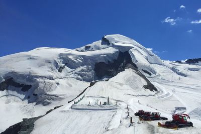 Snow covered mountain against blue sky