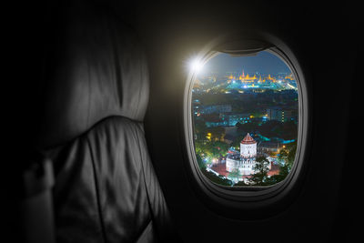 Airplane interior with window view of grand palace bangkok, thailand, travel and air transportation.