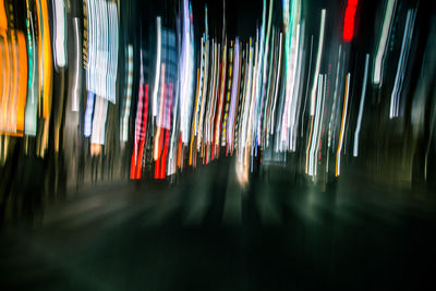 Multi colored lights hanging on road at night