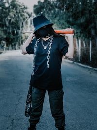 Full length of woman standing on road against trees