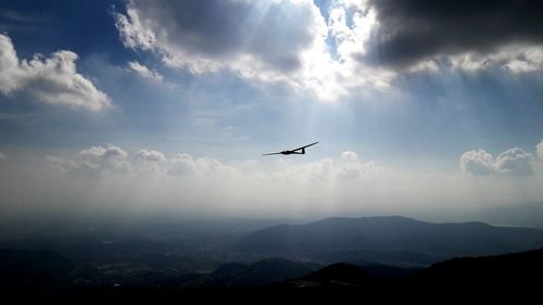 Low angle view of silhouette airplane flying in sky