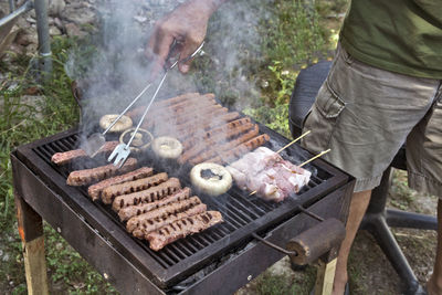 Preparing barbecue meat at picnic in nature. the meat is roasted in a conventional way.