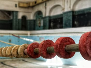 Close-up of rope on railing against building