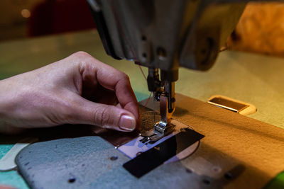 Midsection of person working in machine