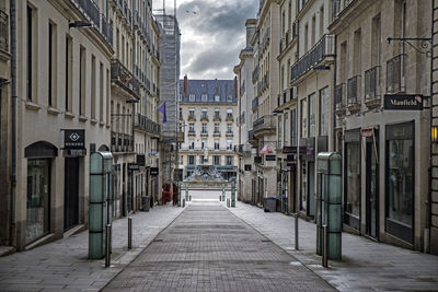 Empty alley amidst buildings in city