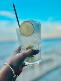Cropped hand of woman holding water