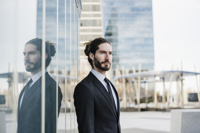 Portrait of young man in city