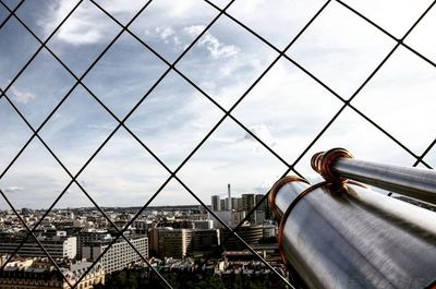 View of cityscape against cloudy sky