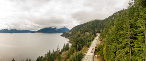 Panoramic view of road by mountains against sky