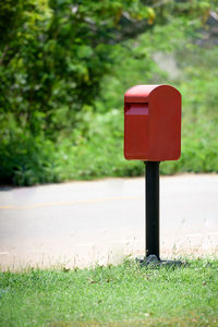 Close-up of red mailbox on field