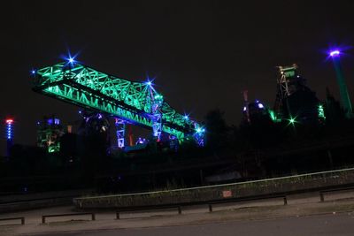 Illuminated city against sky at night