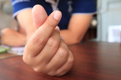 Close-up of hands on table