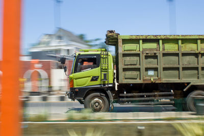 Blurred motion of truck on road in city