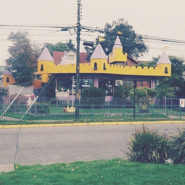 power line, building exterior, architecture, built structure, electricity pylon, cable, power supply, sky, electricity, tree, house, connection, grass, fuel and power generation, outdoors, yellow, fence, day, transportation, residential structure