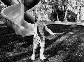 Full length of girl playing in yard