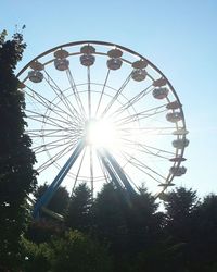 Low angle view of ferris wheel against sky