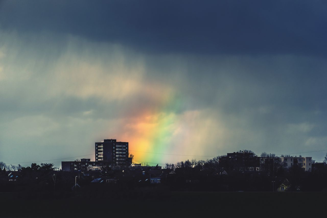 SILHOUETTE BUILDINGS AGAINST DRAMATIC SKY