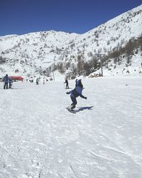 Full length of person skiing on snowcapped mountain