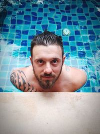 Portrait of smiling young man swimming pool